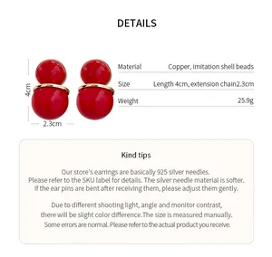 Detail view of red double-sphere stud earrings showing measurements and materials.