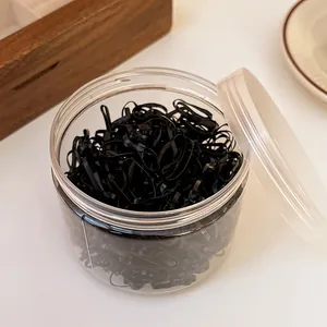 Detailed view of 450 high-elasticity black disposable rubber bands in a transparent jar