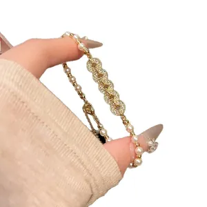 New Chinese style pearl bracelet with zircon encrusted copper coin links in gold finish
