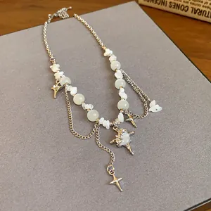 Detailed view of stainless steel necklace with cat's eye stones and star pendants