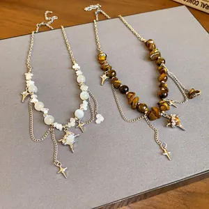 Detail view of irregular tiger eye and cat eye star pendant necklaces