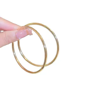 Minimalist gold oval hoop earrings for women, stylish lightweight elegant jewelry design