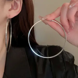 Large silver hoop earrings with a minimalist sleek design for a modern aesthetic
