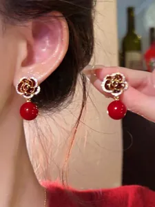Red rose drop earrings with zircons and pearls, elegant New Chinese style jewelry detail.