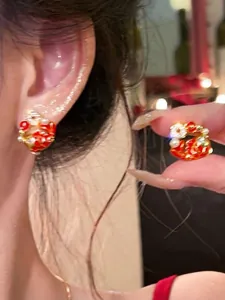 Macro detail of New Chinese style koi carp stud earrings with red enamel and pearls