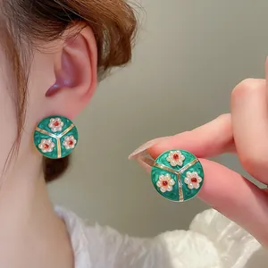 Vintage French style green enamel flower stud earrings with geometric gold details