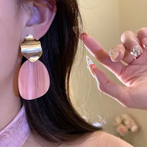 Elegant irregular oval drop earrings made of pink acrylic and gold-toned metal for women