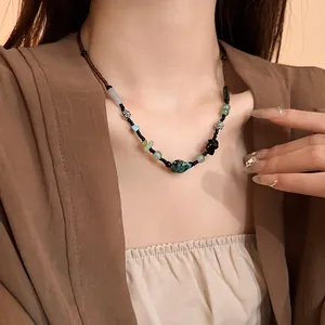 Close-up of New Chinese style beaded necklace with turquoise-like stone and flowers