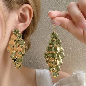 Golden irregular sequin tassel earrings for women with elegant minimalist design