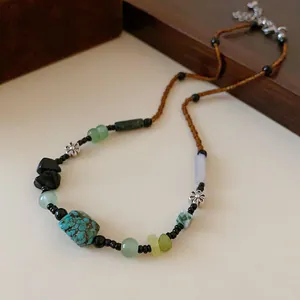 Detailed view of a New Chinese Style beaded necklace with stone charms and silver flowers