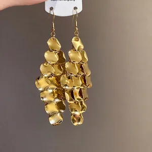 Elegant irregular golden leaf tassel drop earrings with shimmering metallic finish