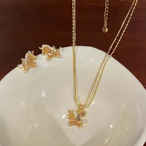 Elegant gold plated unicorn pendant necklace and stud earrings set with amber zircons