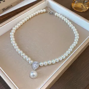 Elegant pearl necklace with teardrop zircon pendant in a luxury display box.