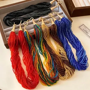 Vintage multi-layer seed bead necklaces in various colors displayed in a jewelry box