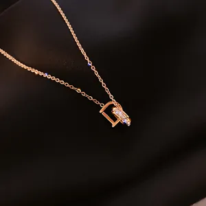 Minimalist rose gold titanium steel necklace featuring a crystal-encrusted D pendant
