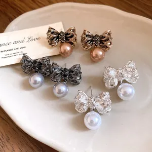 Detailed view of vintage pleated bow pearl drop earrings in three elegant finishes.