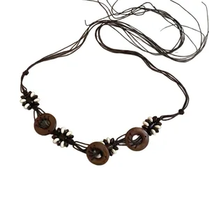 Handmade Bohemian woven waist chain featuring wooden rings and white bead accents for women