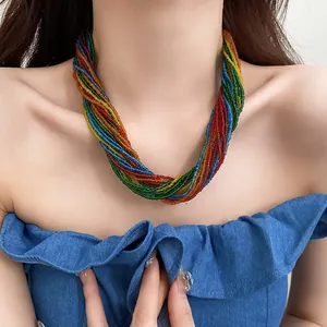 Colorful multi-strand seed bead necklace in rainbow colors worn by a female model.