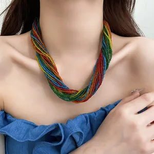 Vibrant multi-strand rainbow seed bead choker necklace worn by a model for a boho chic look.