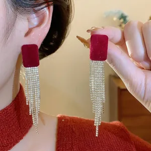 Elegant red velvet square stud earrings with long sparkling rhinestone tassels on model