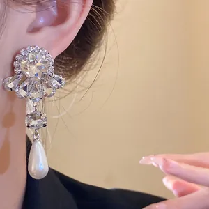 Elegantes pendientes de plata con brillantes diamantes y una perla blanca
