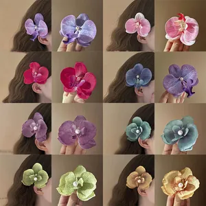 Elegant orchid flower hair clip with pearl center in various soft colors for women