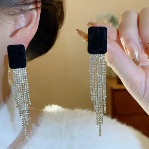Detailed view of elegant black velvet square earrings with long silver rhinestone tassels
