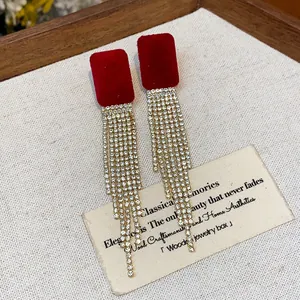 Detailed view of red flocked square earrings with elegant rhinestone tassel fringe