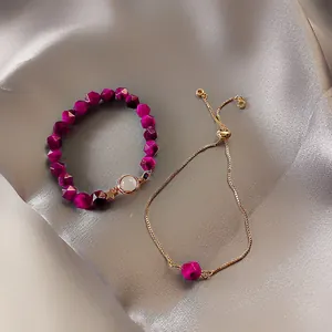 Detail des 2-teiligen Schmucksets mit magentafarbenen Perlen auf Seide