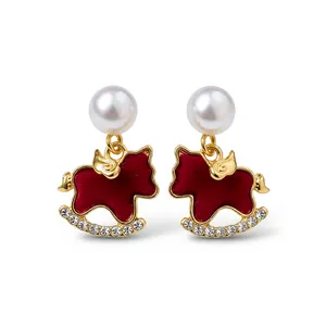 Elegant red rocking horse stud earrings with a white pearl and sparkling crystal accents