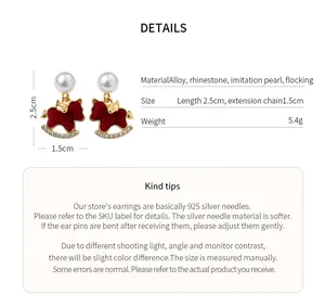 Macro view of red rocking horse stud earrings with imitation pearls and crystals