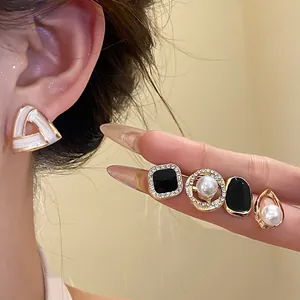 Exquisite detail view of retro French style earring set featuring pearls and rhinestones