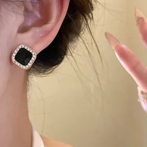Detailed view of vintage French square stud earring featuring black enamel and crystal border