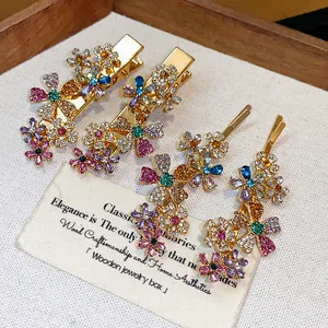 Detailed close-up of sparkling rhinestone flower hair clips on a vintage cream card