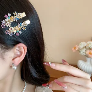 Close-up detail of a sparkling floral rhinestone hair clip worn on elegant dark hair.