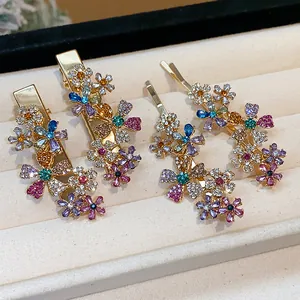 Detailed macro shot of sparkling floral rhinestone hair clips in a jewelry tray