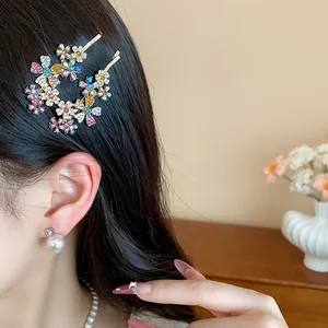 Close-up side view of elegant floral rhinestone hair clip worn by a model with dark hair