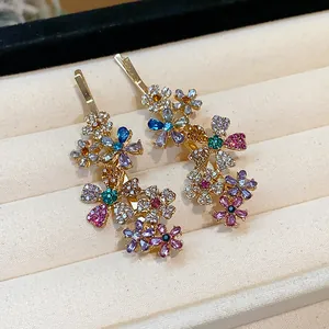 Detailed macro view of sparkling multi-color rhinestone flower hair clips on velvet