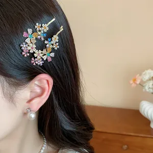 Close-up detail of exquisite colorful rhinestone flower hair clips worn by model