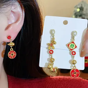 Festive red and gold earrings with horse charm and fortune symbols for Chinese New Year.