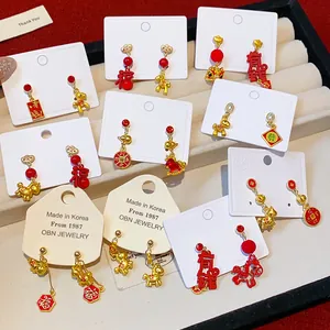 Selection of festive red and gold Chinese New Year earrings with traditional motifs