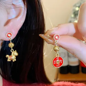 Detailed view of red and gold Chinese New Year horse and lucky coin pendant earrings
