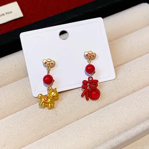Close-up of festive red and gold Fu character and horse earrings for Chinese New Year