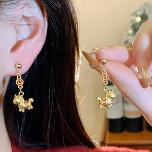 Detailed view of gold pony earrings with Fu character for Chinese New Year