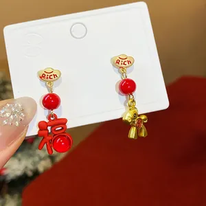 Elegant festive red and gold asymmetric earrings with a horse and Fu character charm