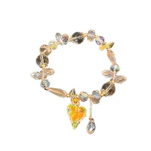 Elegant iridescent crystal bead bracelet featuring a golden heart charm and teardrop accents.