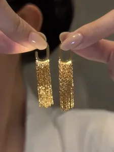 Detailed view of sparkling gold sequin tassel earrings with elegant fringe design