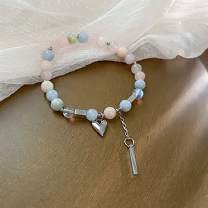 Macro view of multi-colored synthetic crystal beaded bracelet with silver heart charm