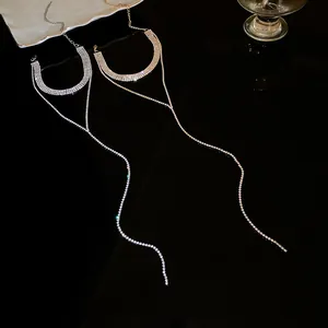 Close-up of sparkling rhinestone tassel necklaces in silver and gold finishes.