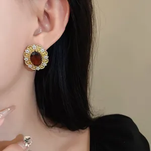 Vintage court style earring with oval amber gemstone and white enamel floral details